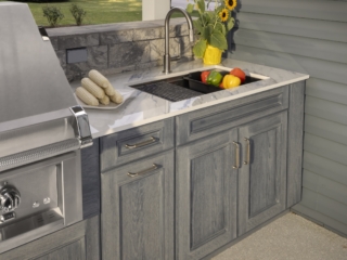 Outdoor kitchen sink, countertop, and gray custom cabinetry in the Jakab project by Mother Hubbard custom cabinetry.